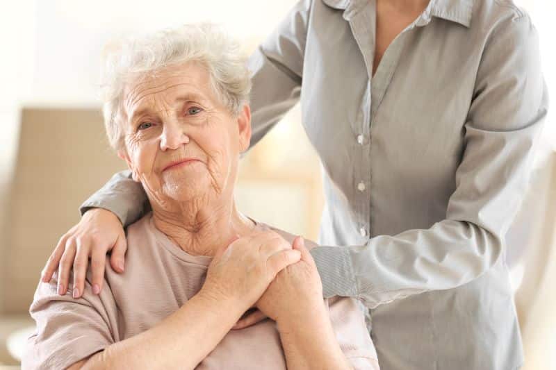 Patient in hospice being comforted by family member