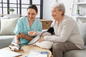 Elderly woman having her blood pressure checked by a nurse in a calm care setting